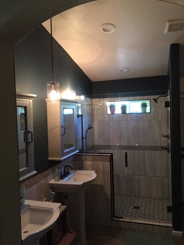 Alcove shower - mid-sized transitional master gray tile and porcelain tile mosaic tile floor and gray floor alcove shower idea in Phoenix with black walls, a pedestal sink and a hinged shower door