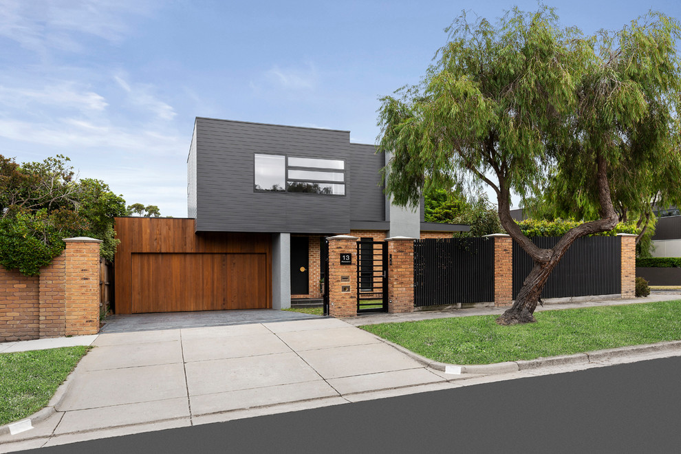 Photo of a mid-sized contemporary two-storey brick black exterior in Melbourne.