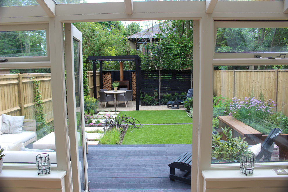 Photo of a small contemporary backyard partial sun formal garden for summer in Hampshire with decking.