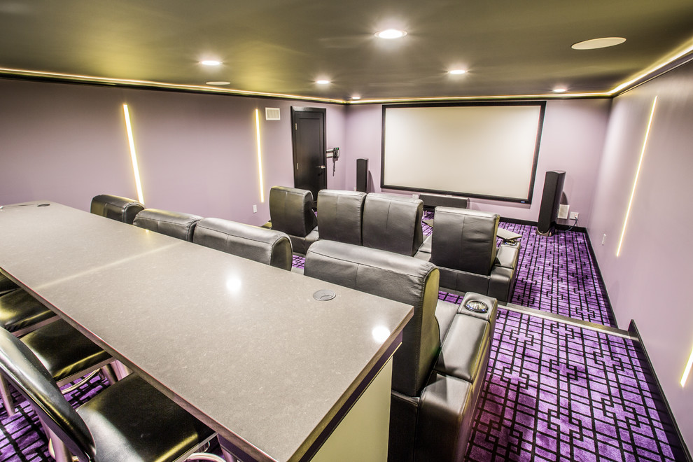 Large modern enclosed home theatre in New York with purple walls, carpet, a projector screen and purple floor.