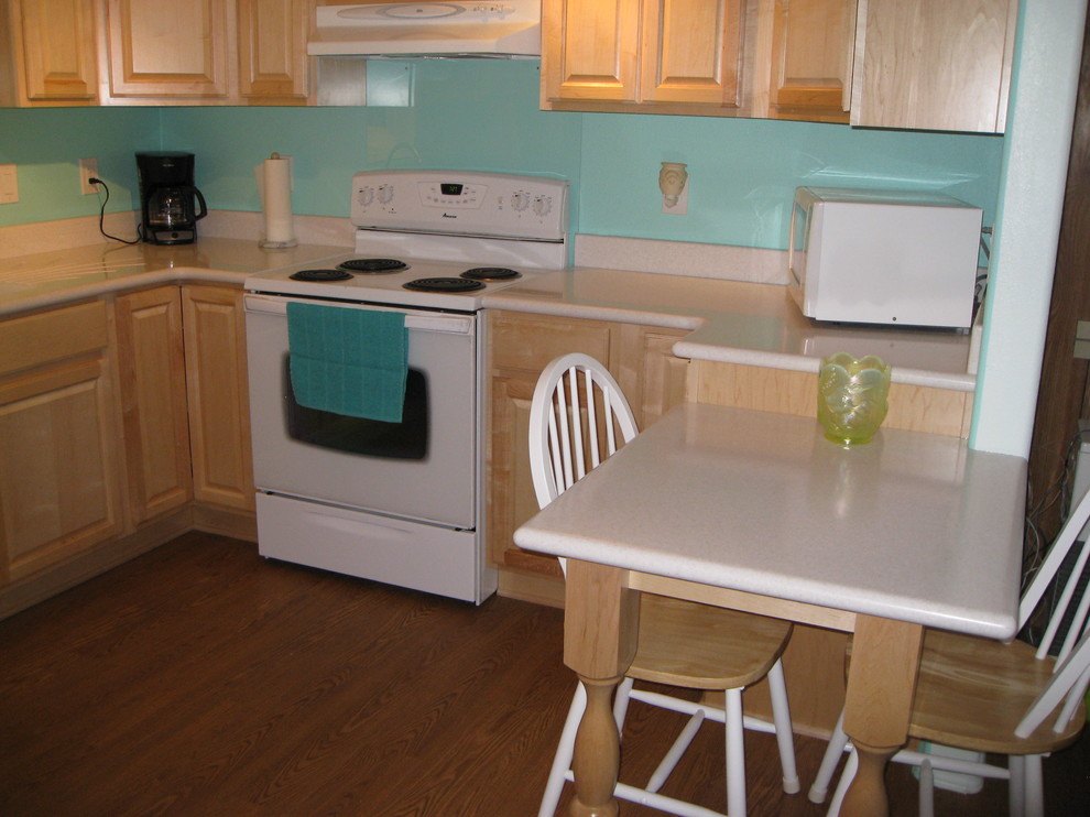 Kitchen - traditional kitchen idea with solid surface countertops and white appliances