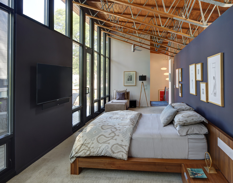 Design ideas for a large contemporary loft-style bedroom in Milwaukee with blue walls, carpet, no fireplace and grey floor.