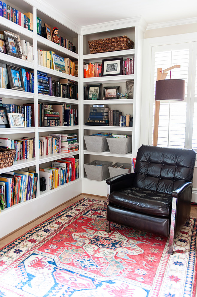 Living room library - mid-sized cottage open concept light wood floor living room library idea in DC Metro with beige walls and no fireplace