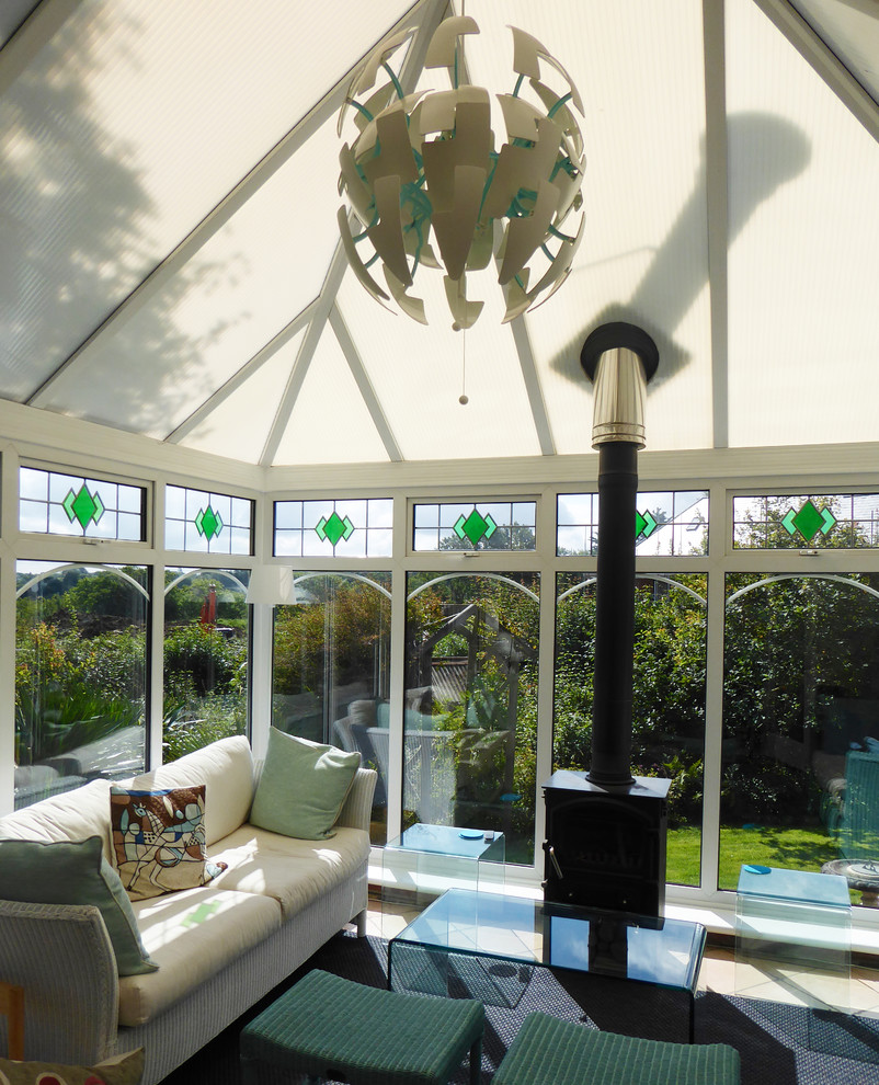 This is an example of an eclectic sunroom in Sussex with ceramic floors and grey floor.