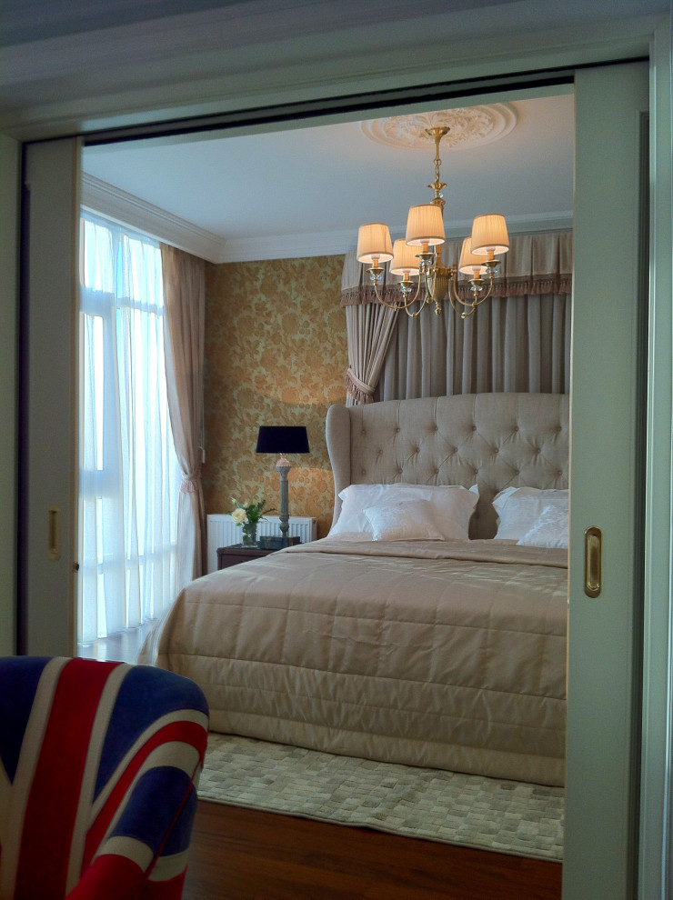 Design ideas for a small traditional master bedroom with beige walls, dark hardwood floors, brown floor and wallpaper.