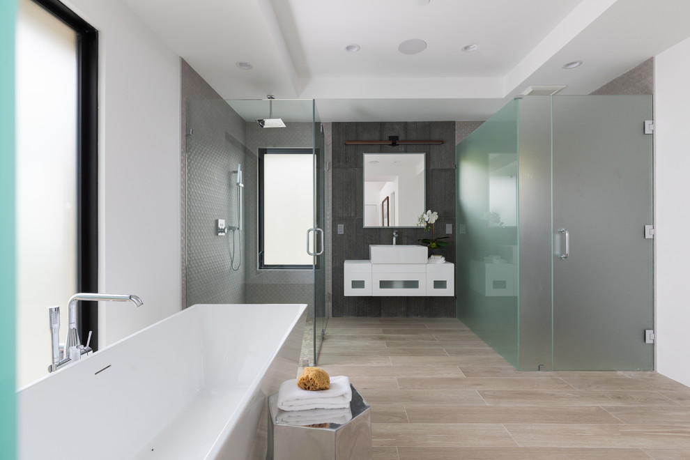 Design ideas for a contemporary master bathroom in San Francisco with flat-panel cabinets, white cabinets, a drop-in tub, a corner shower, gray tile, white walls, a vessel sink, beige floor, a hinged shower door and white benchtops.