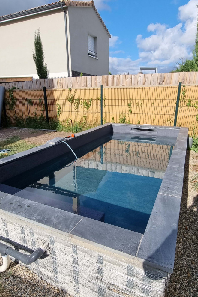 Inspiration for a small modern backyard rectangular aboveground pool in Bordeaux with with a pool and decking.