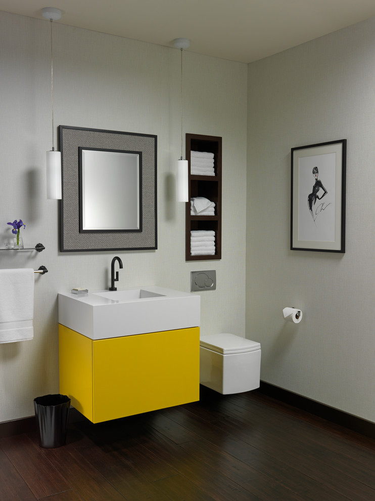 Contemporary bathroom in Sacramento with flat-panel cabinets, yellow cabinets, engineered quartz benchtops, a wall-mount toilet, white walls, dark hardwood floors, a console sink and brown floor.