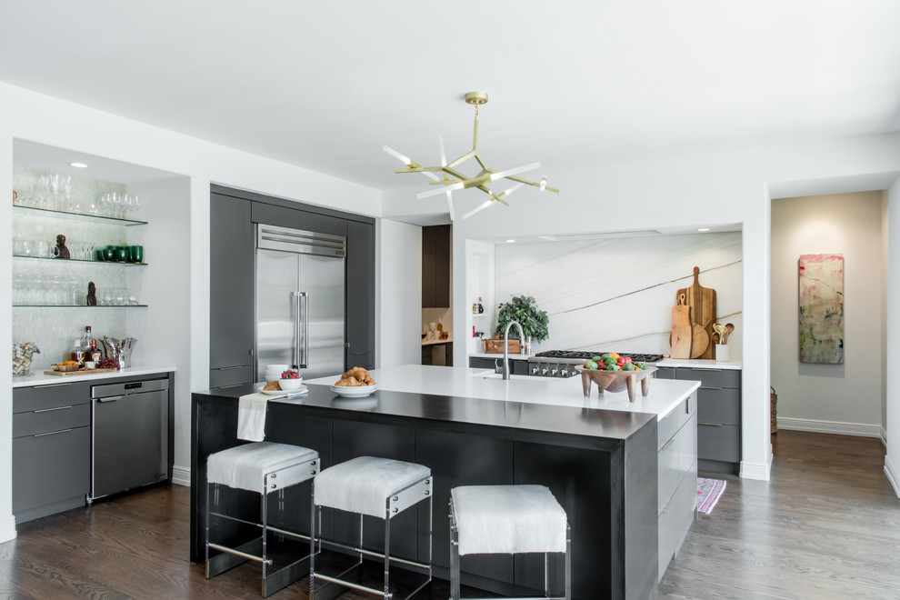 Photo of a large contemporary l-shaped open plan kitchen in Other with a farmhouse sink, flat-panel cabinets, grey cabinets, marble benchtops, white splashback, marble splashback, stainless steel appliances, medium hardwood floors, with island, brown floor and white benchtop.