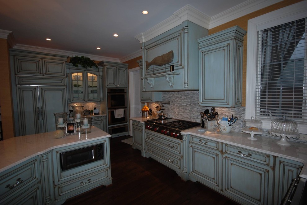 Inspiration for a large transitional kitchen remodel with raised-panel cabinets, marble countertops, multicolored backsplash and ceramic backsplash