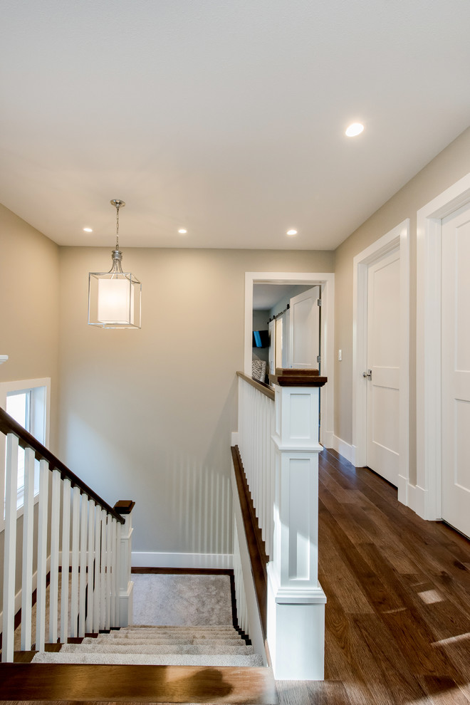 This is an example of a mid-sized arts and crafts hallway in Other with grey walls, laminate floors and brown floor.