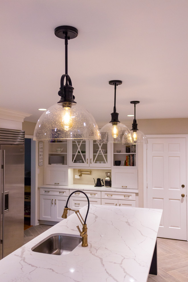 Transitional brown floor kitchen photo with an island