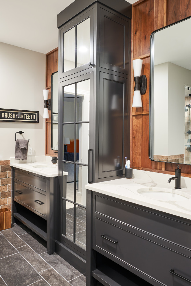 Mid-sized transitional kids bathroom in Cleveland with shaker cabinets, black cabinets, a corner shower, brown tile, stone tile, porcelain floors, a drop-in sink, engineered quartz benchtops, black floor, a hinged shower door, white benchtops, a double vanity, a built-in vanity and brick walls.