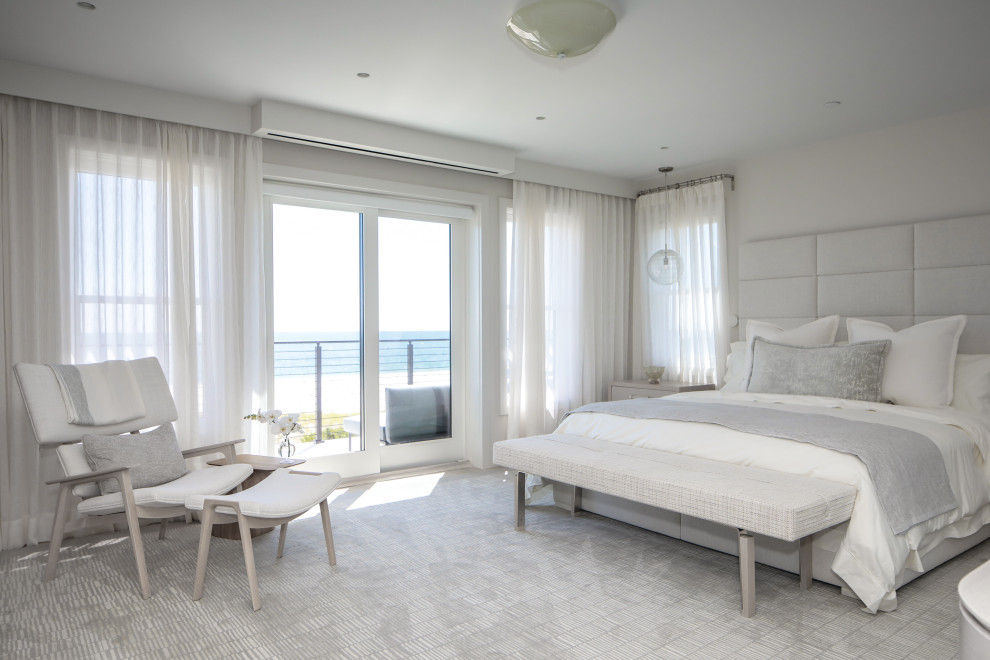Design ideas for a mid-sized modern master bedroom in New York with beige walls and light hardwood floors.