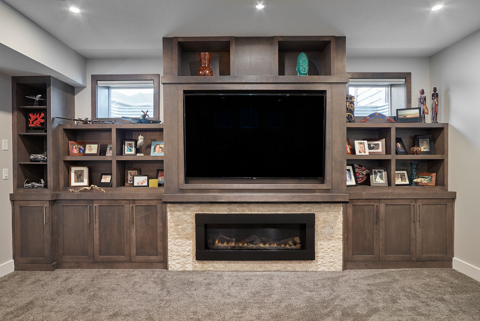 This is an example of a mid-sized transitional look-out basement in Edmonton with grey walls, carpet, a ribbon fireplace, a stone fireplace surround and brown floor.