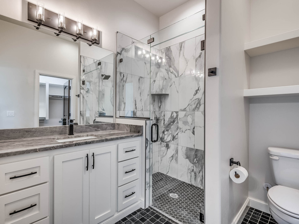 Photo of a large country bathroom in Oklahoma City with white cabinets, a shower/bathtub combo, black and white tile, glass tile, beige walls, porcelain floors, an undermount sink, quartzite benchtops, white floor, an open shower, a single vanity and a freestanding vanity.