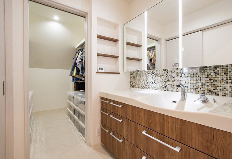 Inspiration for a mid-sized modern powder room in Other with flat-panel cabinets, white cabinets, brown tile, mosaic tile, white walls, a wall-mount sink, solid surface benchtops, beige floor, white benchtops, a freestanding vanity, wallpaper and wallpaper.
