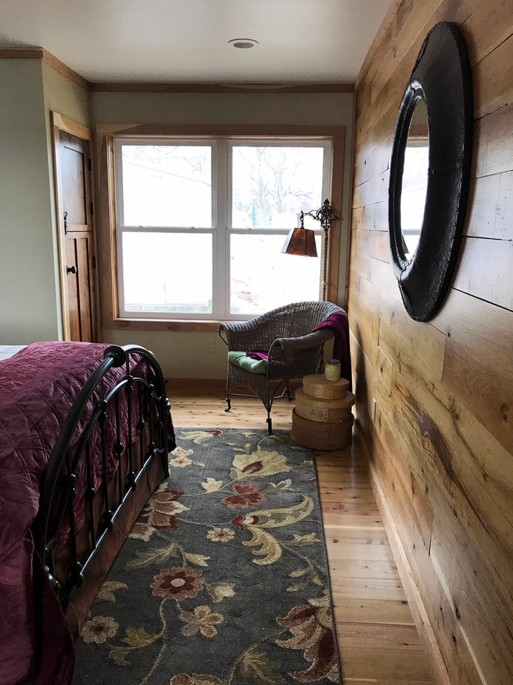 Mid-sized country master bedroom in Grand Rapids with medium hardwood floors.
