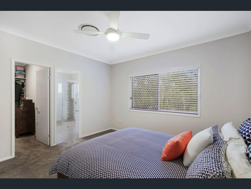 Design ideas for a modern master bedroom in Other with carpet and brown floor.