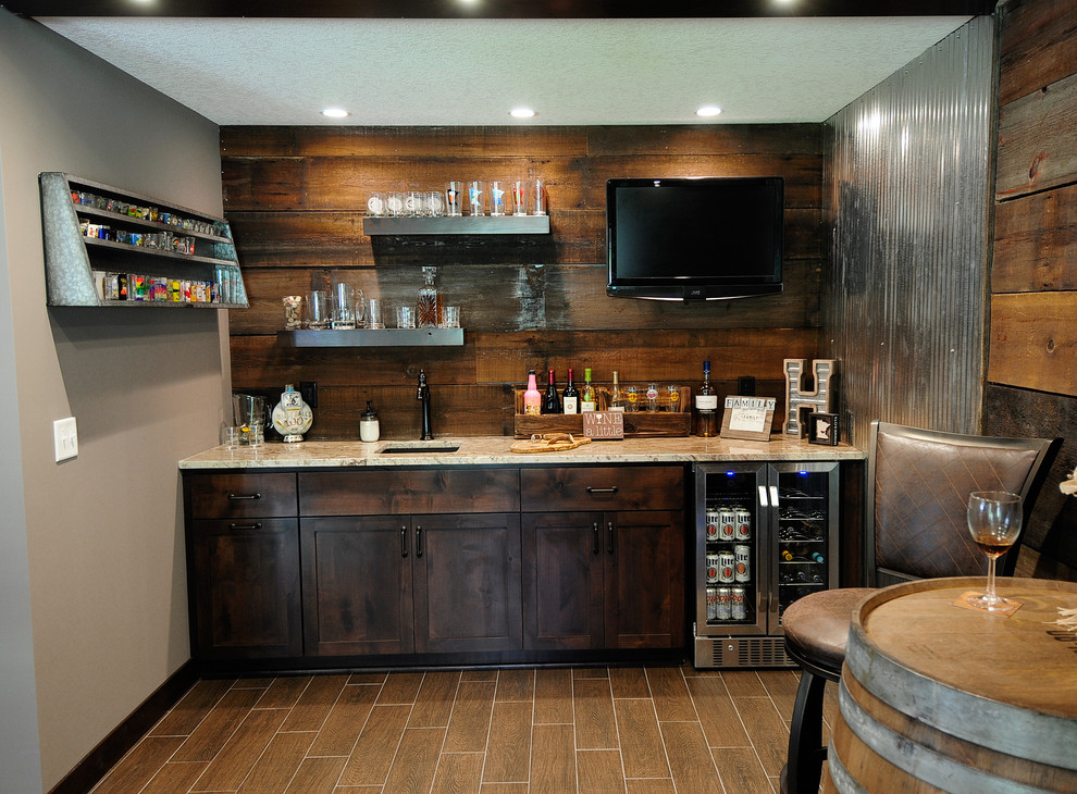 Inspiration for a large single-wall wet bar in Minneapolis with an undermount sink, shaker cabinets, dark wood cabinets, granite benchtops, brown splashback, timber splashback, travertine floors and brown floor.