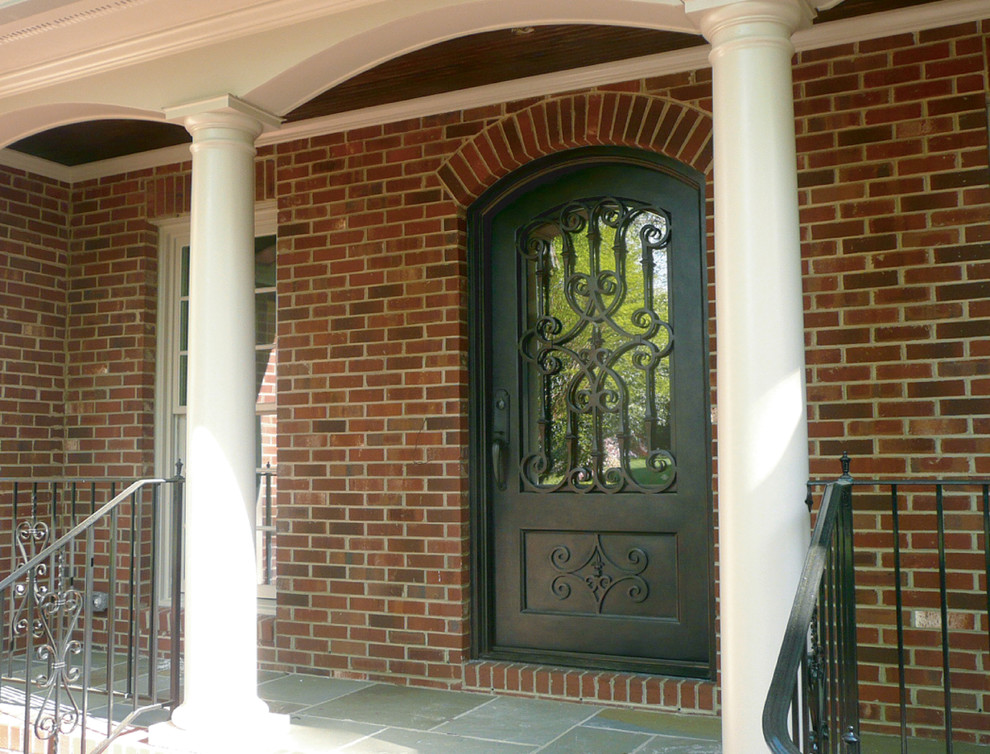 Example of a slate floor single front door design in Charlotte with a black front door