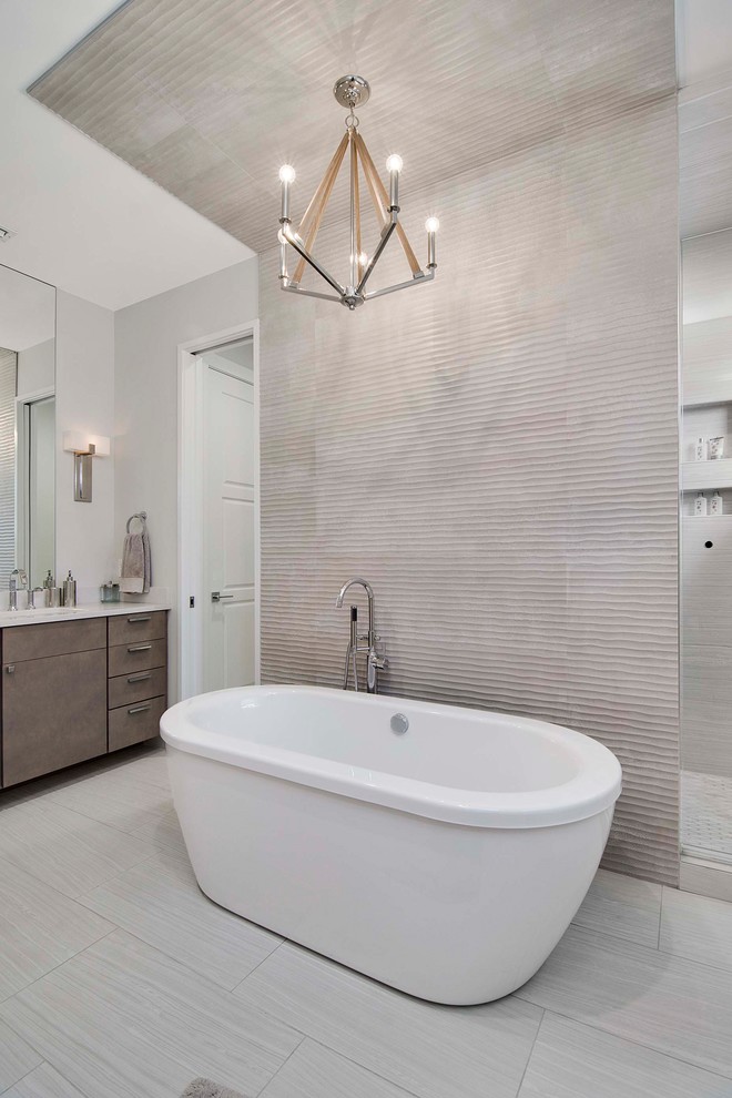 This is an example of a large beach style master bathroom in Orlando with a freestanding tub, an open shower, gray tile, porcelain tile, ceramic floors, a drop-in sink, marble benchtops, a hinged shower door and white benchtops.