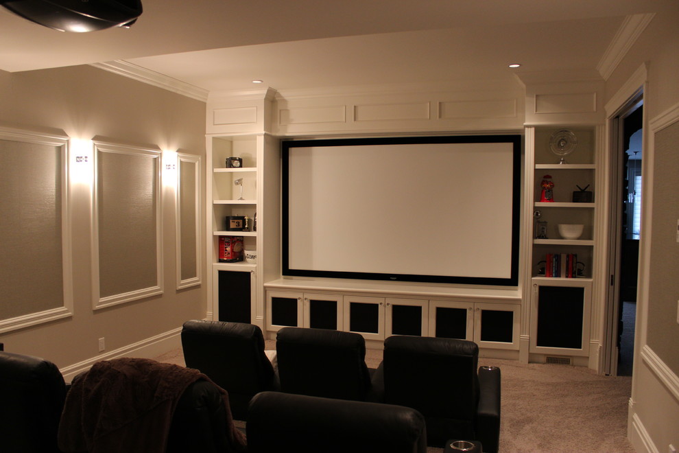 This is an example of a large modern enclosed home theatre in Calgary with beige walls, carpet, beige floor and a projector screen.