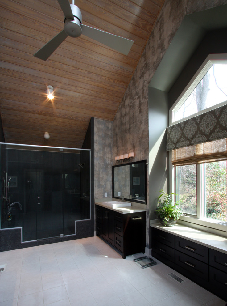 Photo of an expansive modern master bathroom in Richmond with a drop-in sink, shaker cabinets, dark wood cabinets, concrete benchtops, a drop-in tub, an alcove shower, a bidet, gray tile, stone tile, beige walls and ceramic floors.
