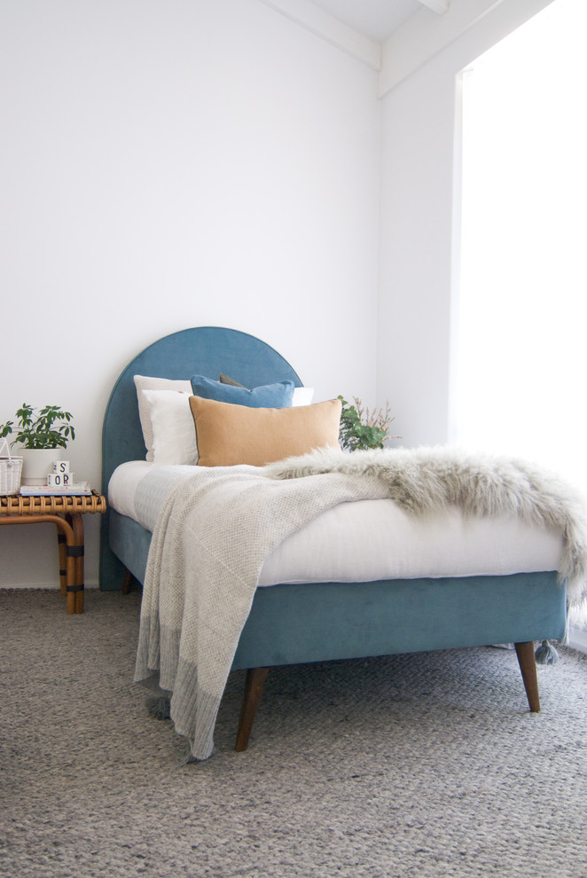 This is an example of a small beach style gender-neutral kids' bedroom in Other with white walls, carpet and grey floor.