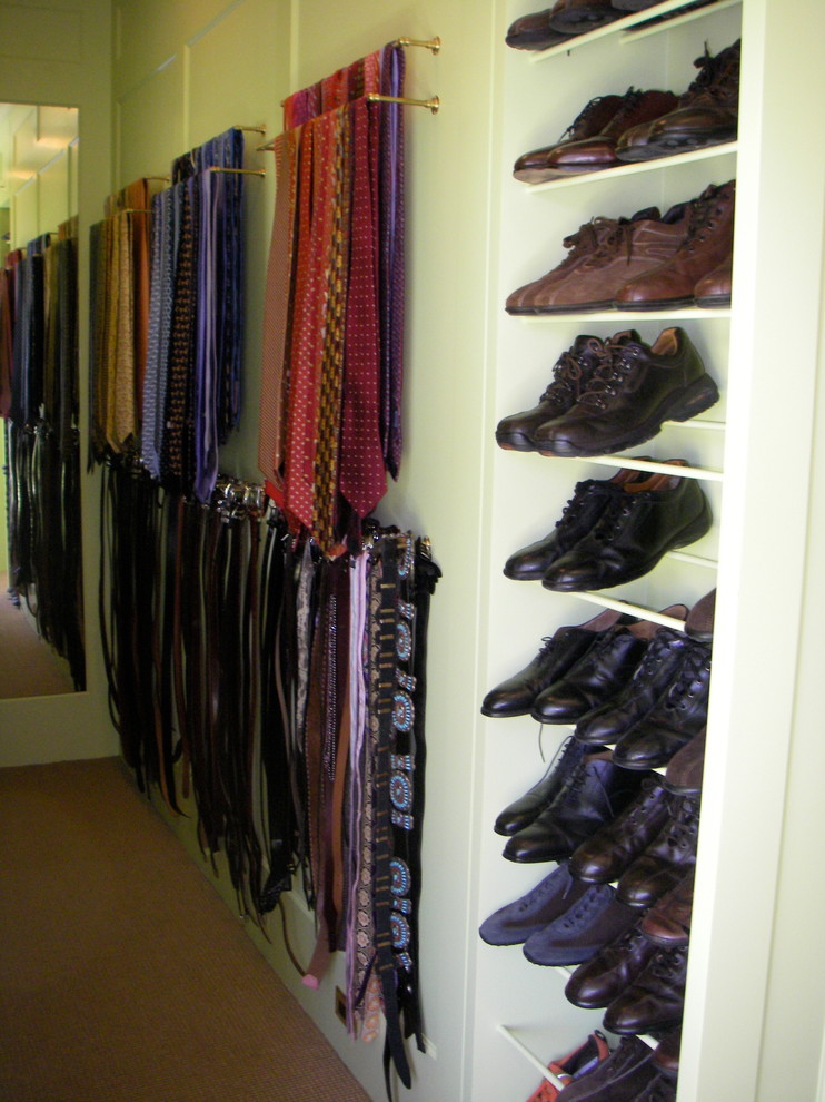 This is an example of a large traditional men's walk-in wardrobe in San Francisco with open cabinets, carpet and brown floor.