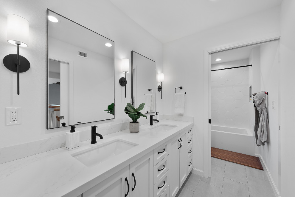 Design ideas for a large classic family bathroom in Los Angeles with shaker cabinets, white cabinets, a built-in bath, a shower/bath combination, a one-piece toilet, white walls, cement flooring, a submerged sink, quartz worktops, grey floors, a shower curtain, white worktops, an enclosed toilet, double sinks and a built in vanity unit.