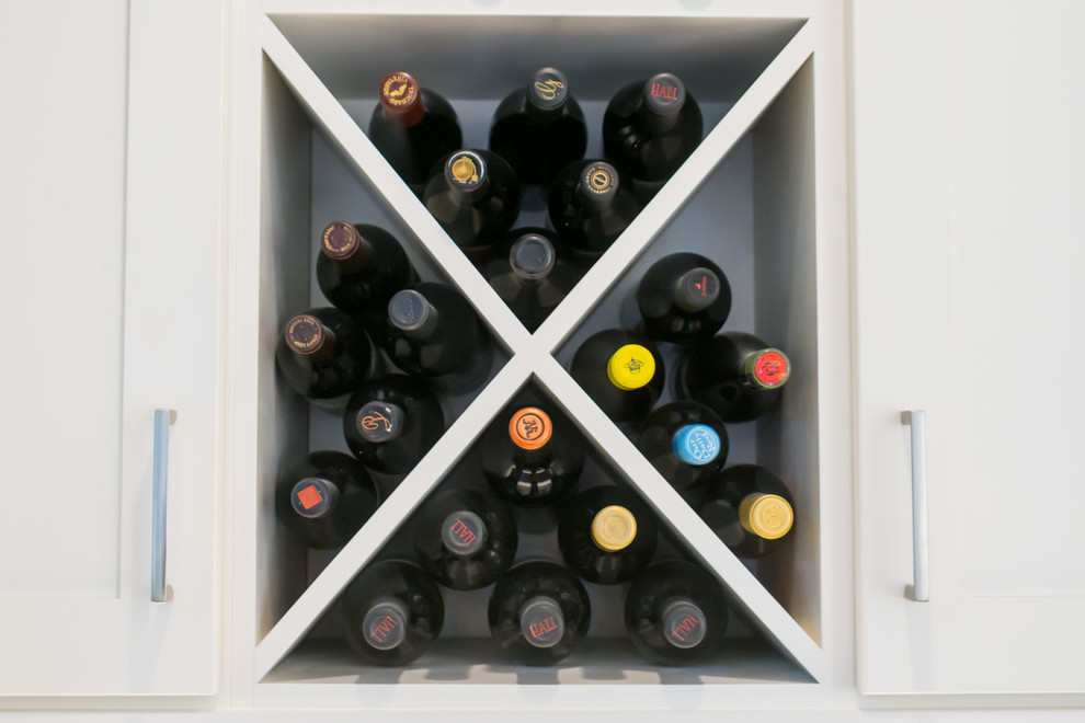 Wine cellar - large transitional u-shaped dark wood floor and brown floor wine cellar idea in Atlanta with a farmhouse sink, shaker cabinets, white cabinets, beige backsplash, stainless steel appliances, an island, white countertops, quartz countertops and cement tile backsplash