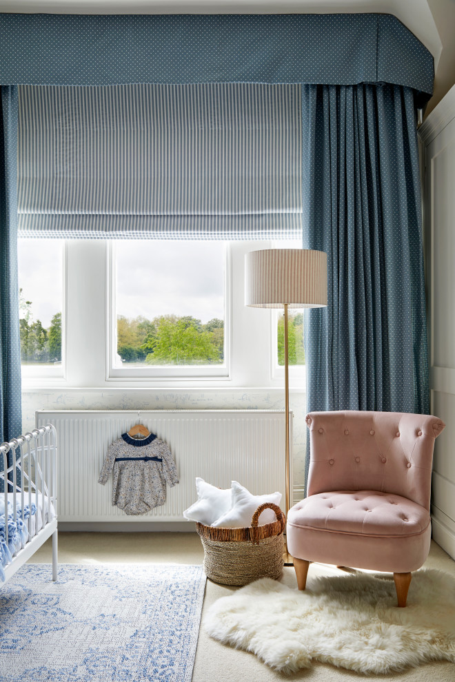 This is an example of a medium sized classic gender neutral toddler’s room in London with blue walls, carpet, beige floors, a coffered ceiling and wallpapered walls.