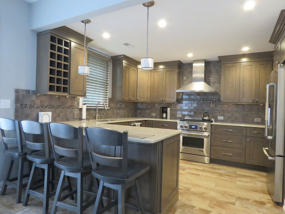 Mid-sized transitional u-shaped ceramic tile and beige floor eat-in kitchen photo in Philadelphia with an undermount sink, shaker cabinets, gray cabinets, quartzite countertops, gray backsplash, subway tile backsplash, stainless steel appliances and an island