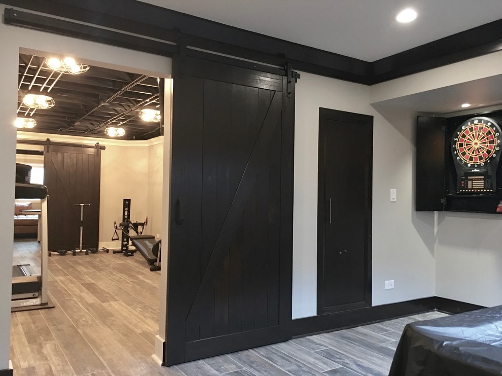 Inspiration for a mid-sized transitional underground dark wood floor and brown floor basement remodel in Chicago with beige walls and no fireplace