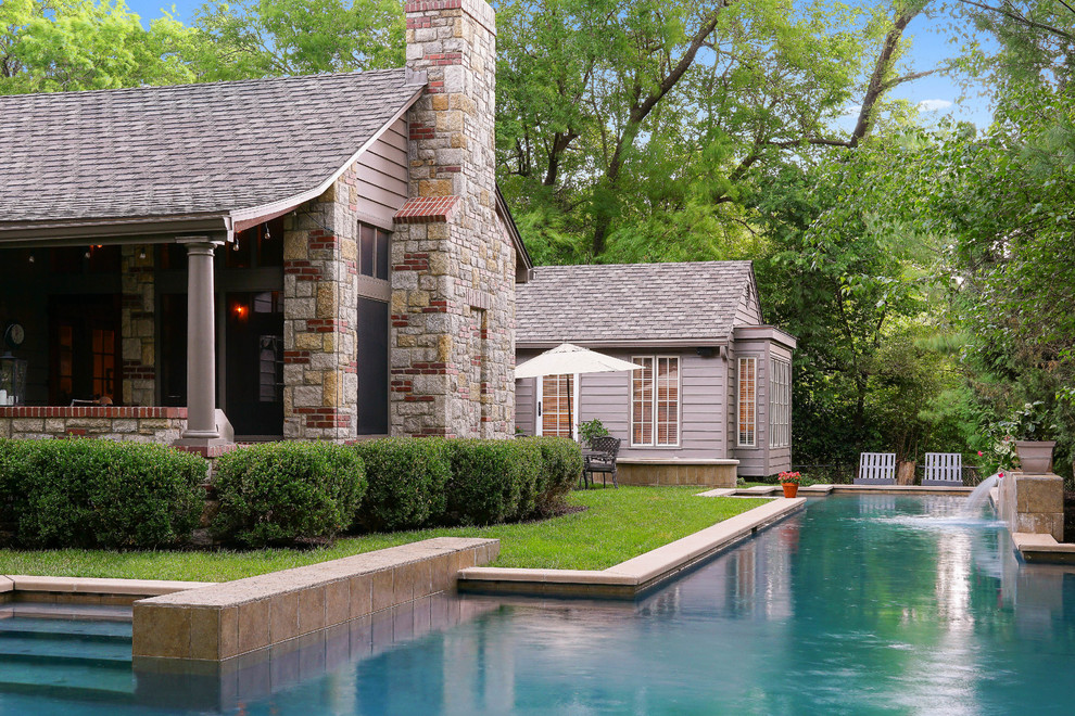 This is an example of a traditional l-shaped pool in Kansas City with a pool house.