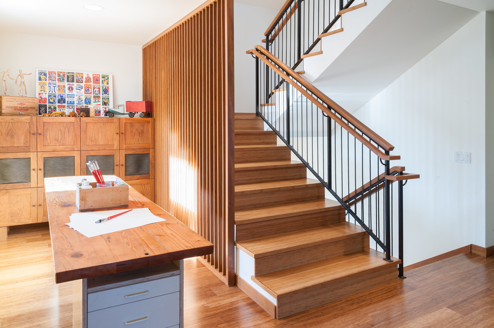 Contemporary wood u-shaped staircase in Seattle with wood risers and mixed railing.