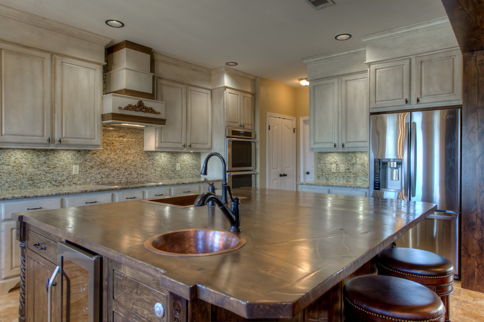 Eat-in kitchen - mid-sized rustic l-shaped eat-in kitchen idea in Austin with a single-bowl sink, wood countertops, stainless steel appliances and an island