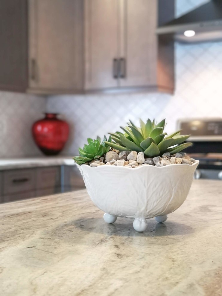 Mid-sized transitional l-shaped medium tone wood floor and brown floor open concept kitchen photo in Toronto with an undermount sink, shaker cabinets, light wood cabinets, granite countertops, white backsplash, porcelain backsplash, stainless steel appliances, an island and beige countertops