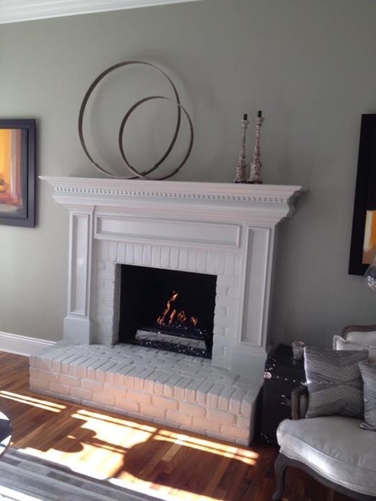Photo of a mid-sized contemporary living room in Columbus with a standard fireplace and a brick fireplace surround.