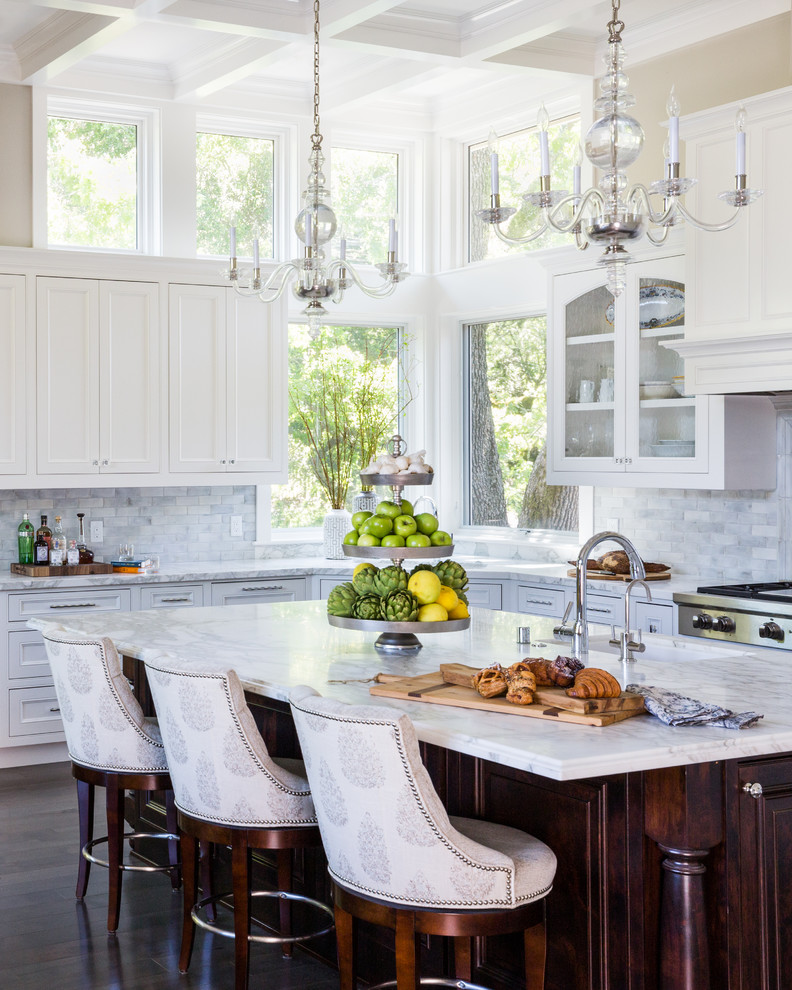 Inspiration for a large traditional l-shaped kitchen in San Francisco with glass-front cabinets, white cabinets, marble benchtops, with island, a single-bowl sink, white splashback, marble splashback, stainless steel appliances, dark hardwood floors and brown floor.