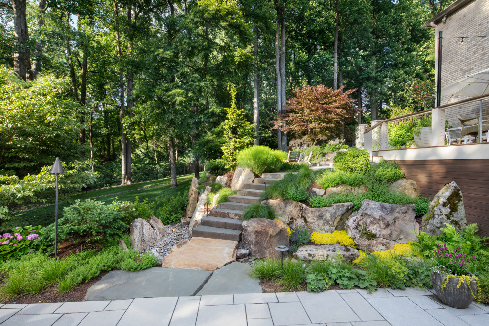 Photo of a transitional rock backyard stone landscaping in DC Metro.