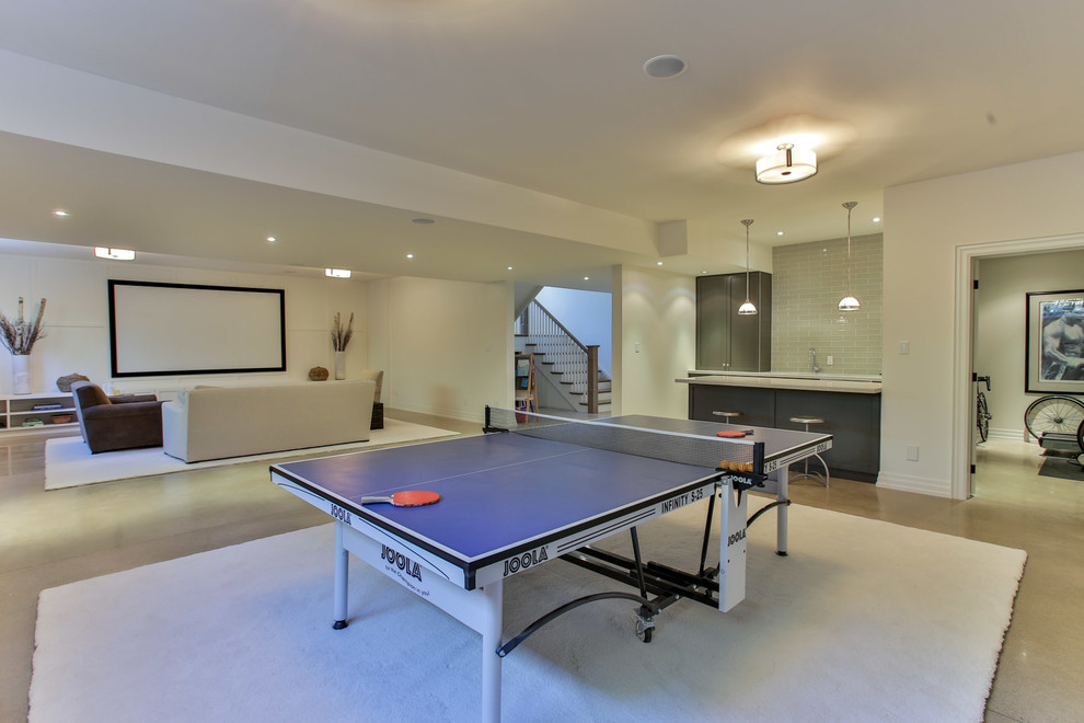 Inspiration for a huge transitional underground concrete floor basement remodel in Toronto with white walls and no fireplace