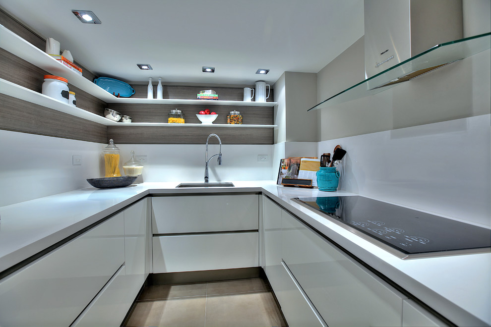 Photo of a contemporary separate kitchen in Miami with a single-bowl sink, open cabinets, white cabinets and white splashback.
