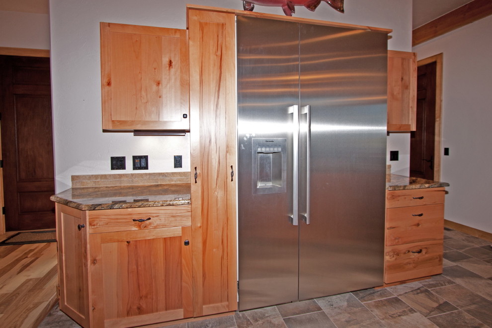 Example of a large mountain style eat-in kitchen design in Houston with medium tone wood cabinets, an island and shaker cabinets