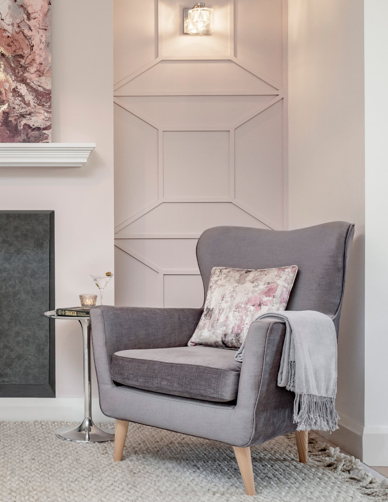 Contemporary living room in Surrey with pink walls, carpet, a wood stove and panelled walls.