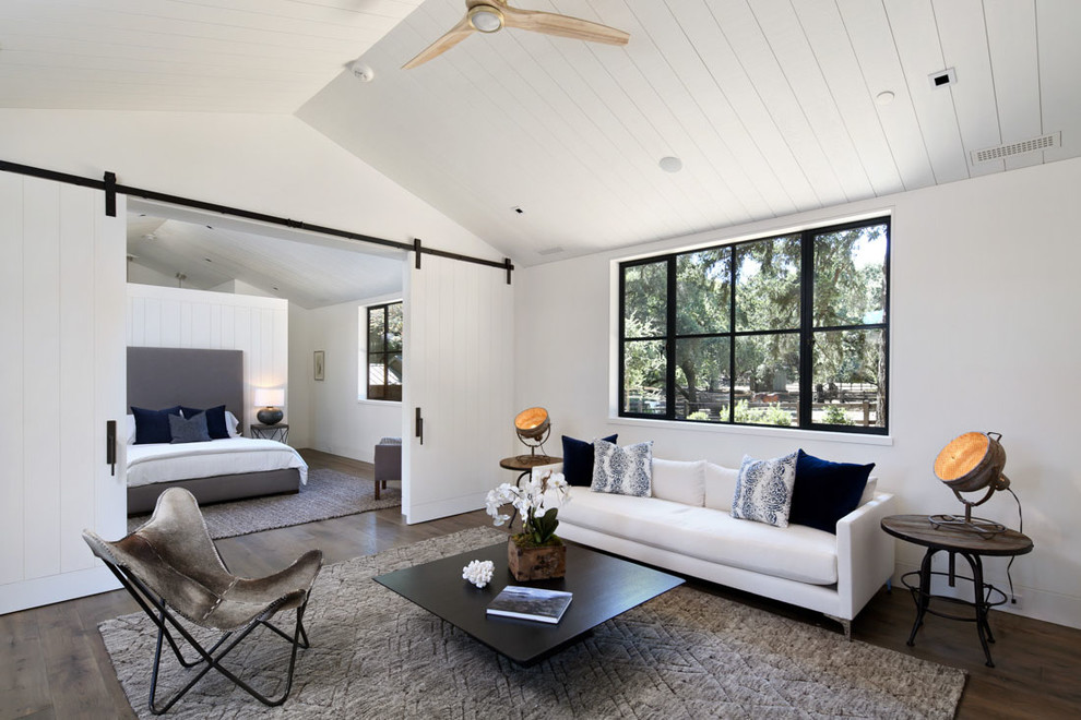 Design ideas for a country master bedroom in Los Angeles with white walls and dark hardwood floors.