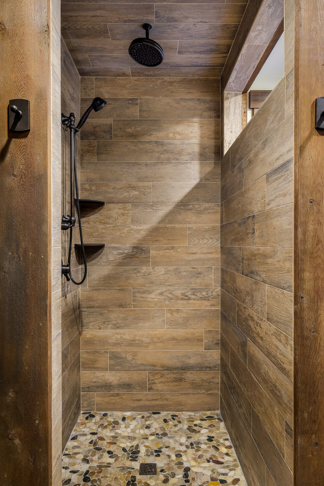 Inspiration for a mid-sized country 3/4 bathroom in Denver with shaker cabinets, dark wood cabinets, a corner shower, a two-piece toilet, brown tile, multi-coloured tile, stone tile, beige walls, porcelain floors and granite benchtops.