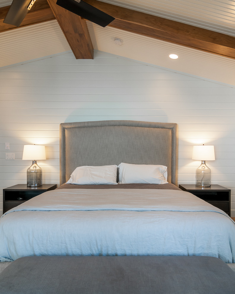 Example of a large transitional master light wood floor and beige floor bedroom design with white walls