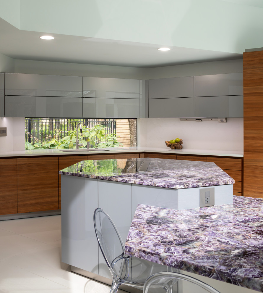 Mid-sized contemporary eat-in kitchen in Houston with an undermount sink, flat-panel cabinets, medium wood cabinets, solid surface benchtops, stainless steel appliances, porcelain floors, with island, white floor and purple benchtop.